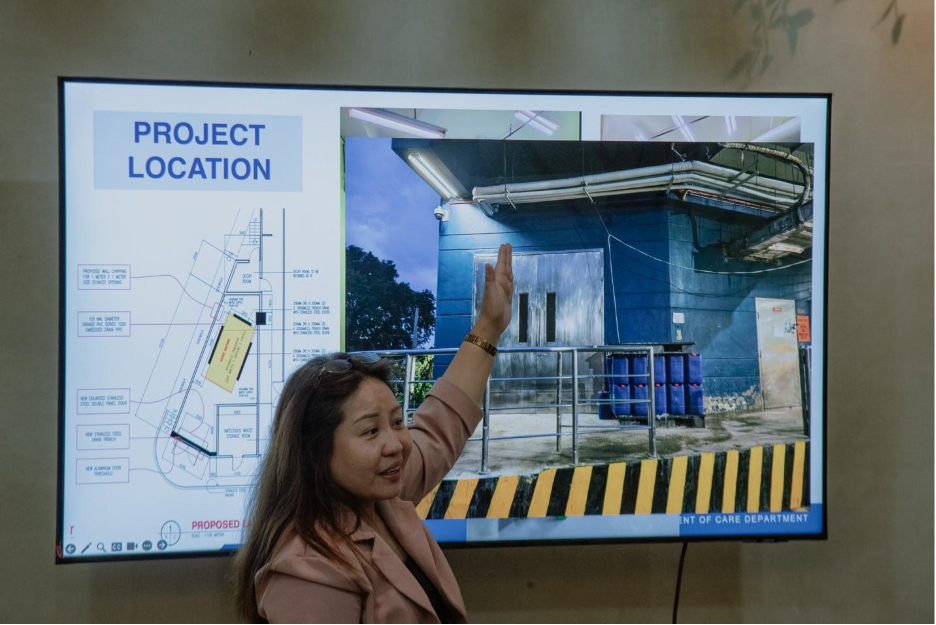 A person raising her hand in front of a projector screen

AI-generated content may be incorrect.