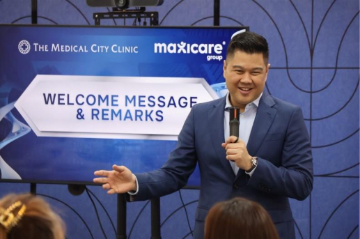 A person in a suit speaking into a microphone

AI-generated content may be incorrect.