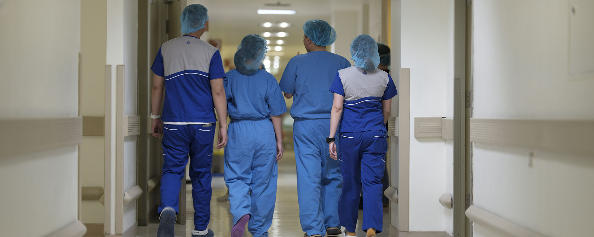 group of medical personnel walking down the hospital hallway