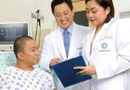 female and male doctors discussing with a patient