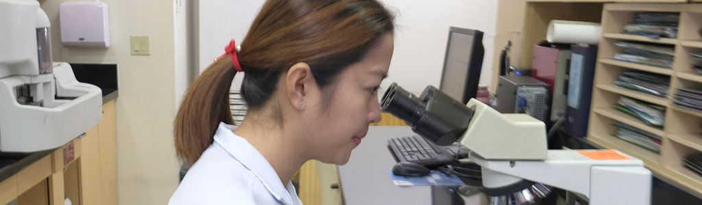 medical technician looking thru a telescope