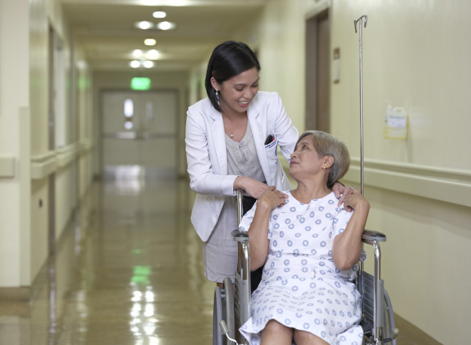 female doctor assisting an elder patient