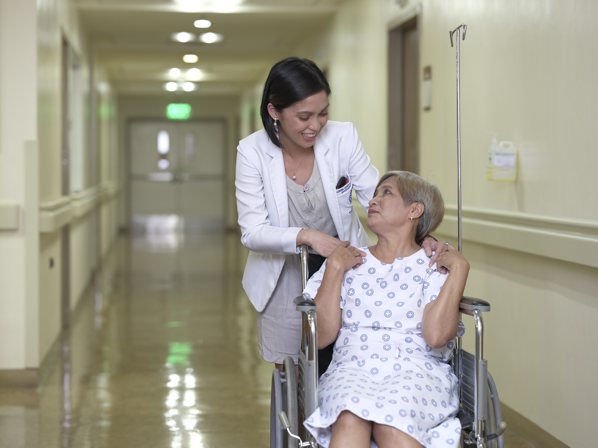 female doctor assisting an elder female patient