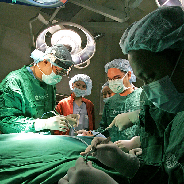 group of doctors performing surgery