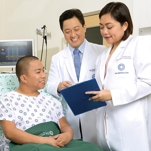 male and female doctor discussing with a male patient