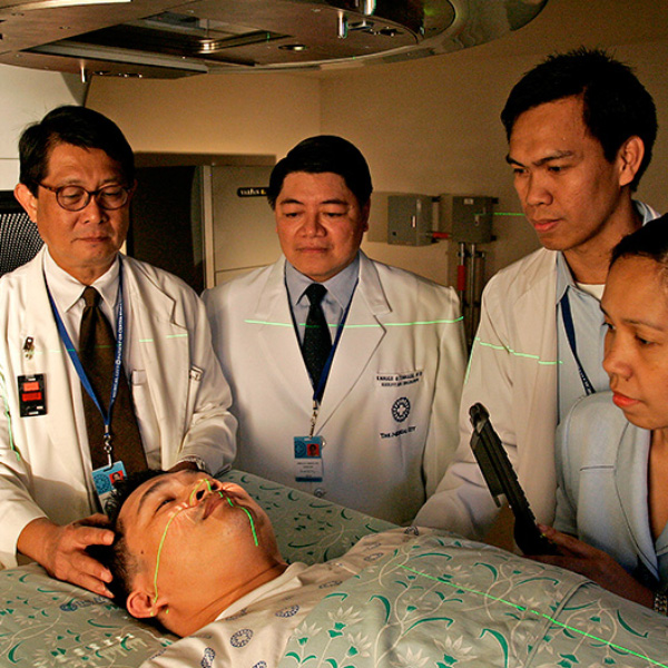 group of doctors analying a male patients head