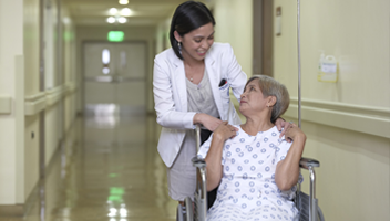 female doctor assisting an elder female patient