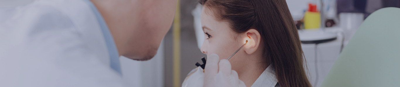 male doctor examining a female patients ear