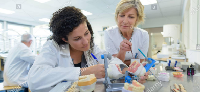 female medical personnel analyzing a specimen 