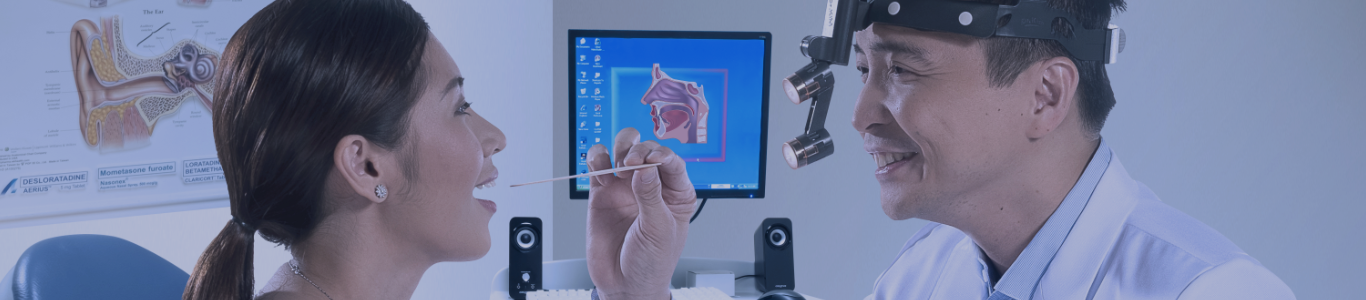 male doctor examining a female patients mouth