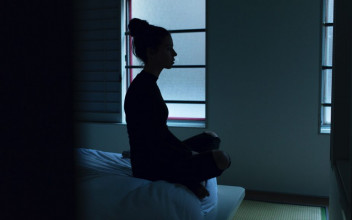 woman sitting on bed