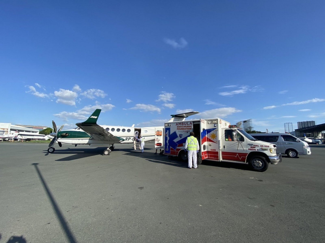 ambulance next to a private plane