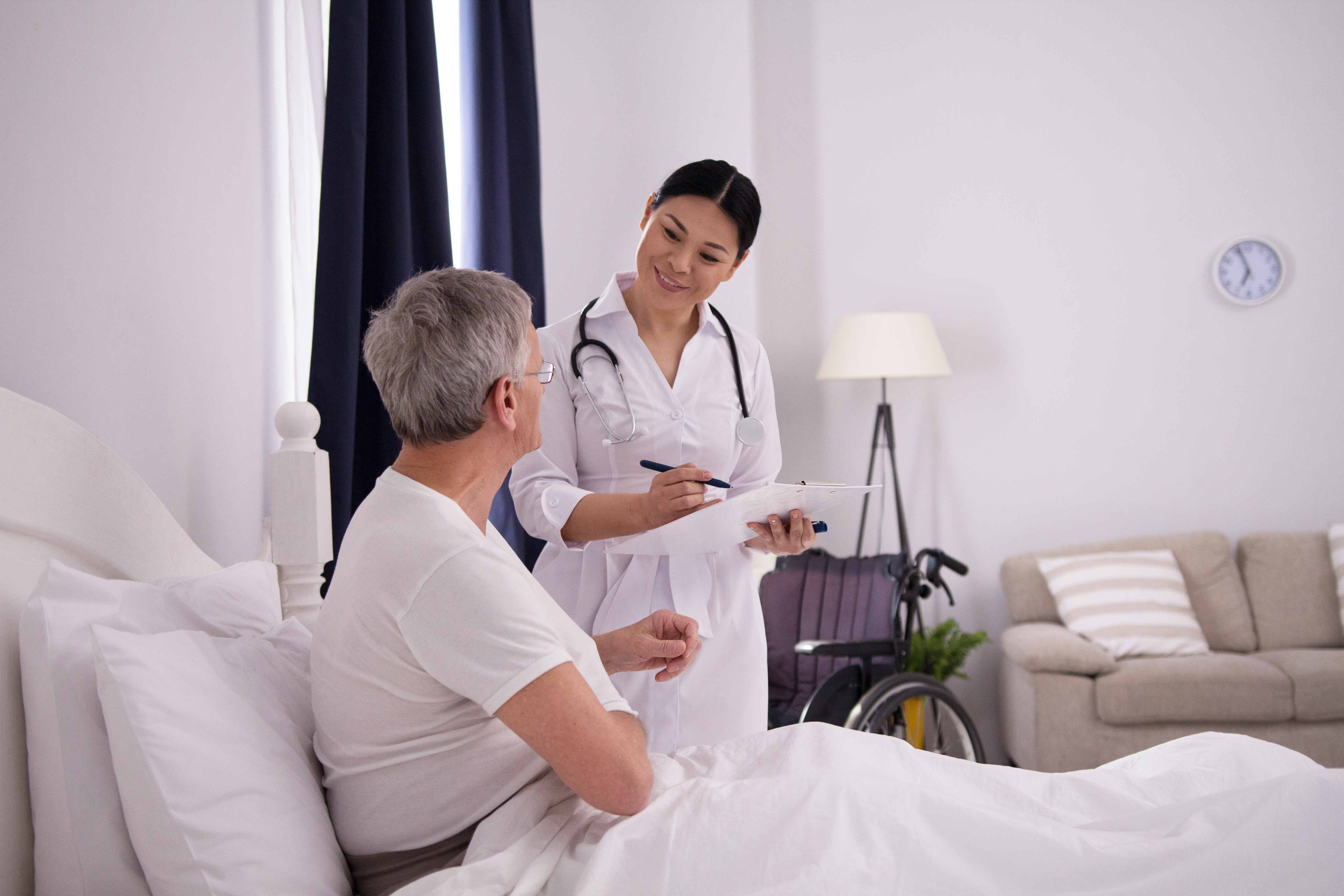 female nurse discussing with an elder female patient