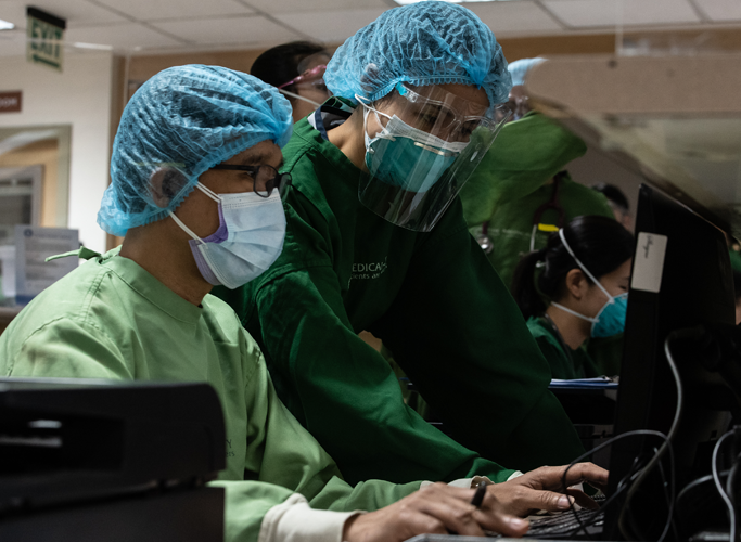 group doctors looking at computer screen