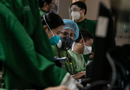 group of doctors looking through a computer screen