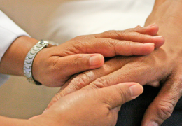 doctor holding a patients hand