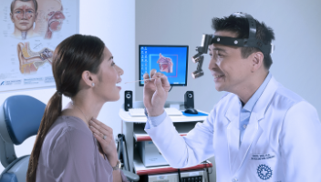 male doctor inspecting a female patients throat