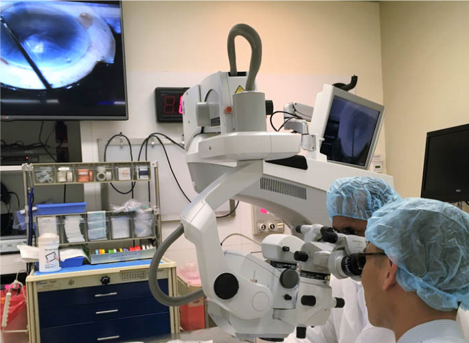 two doctors looking thru a medical device